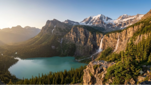 A serene and awe-inspiring landscape featuring a backpacker standing on a steep rocky cliff, looking out over a stunning emerald lake. The lake is surrounded by dense evergreen forests, massive dual waterfalls cascading down the cliffs, and majestic snow-capped mountain peaks in the background.